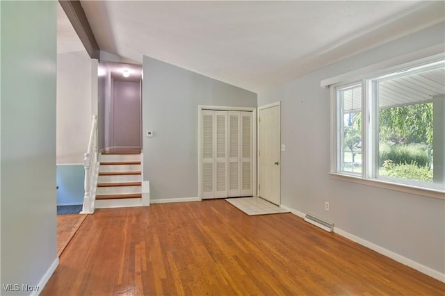 entrance foyer featuring vaulted ceiling and hardwood / wood-style floors