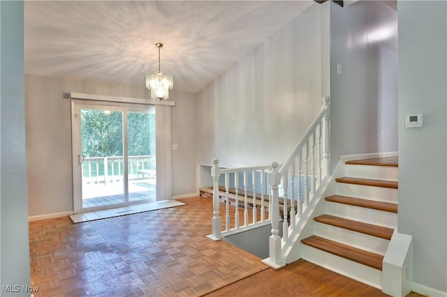 entryway featuring parquet flooring and an inviting chandelier