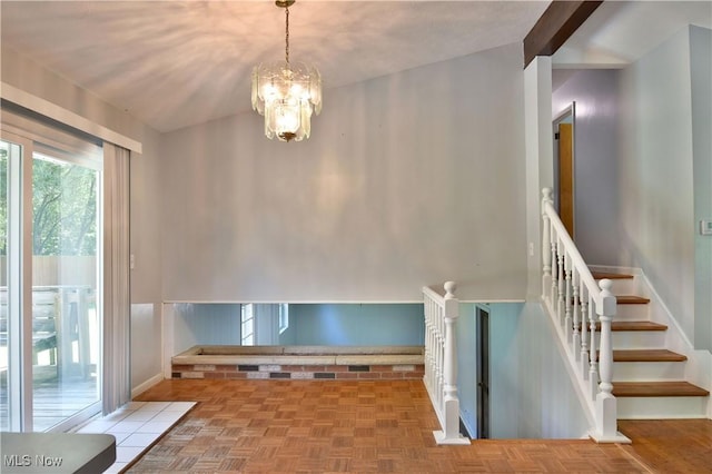 stairway featuring an inviting chandelier, parquet flooring, and vaulted ceiling