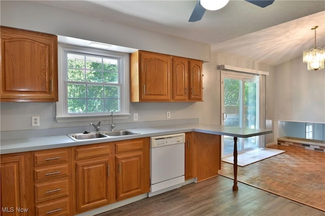 kitchen with dishwasher, plenty of natural light, dark wood-type flooring, and decorative light fixtures