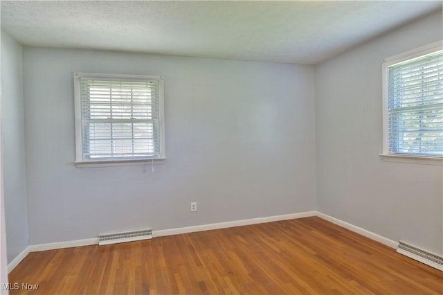 unfurnished room with wood-type flooring