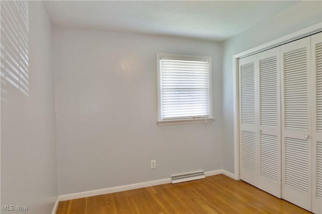 unfurnished bedroom with light hardwood / wood-style floors and a closet