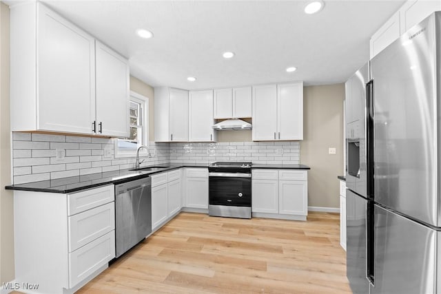 kitchen featuring stainless steel appliances, sink, white cabinets, and light hardwood / wood-style floors