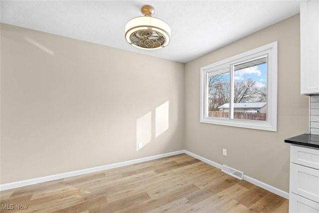 unfurnished dining area with light wood-type flooring