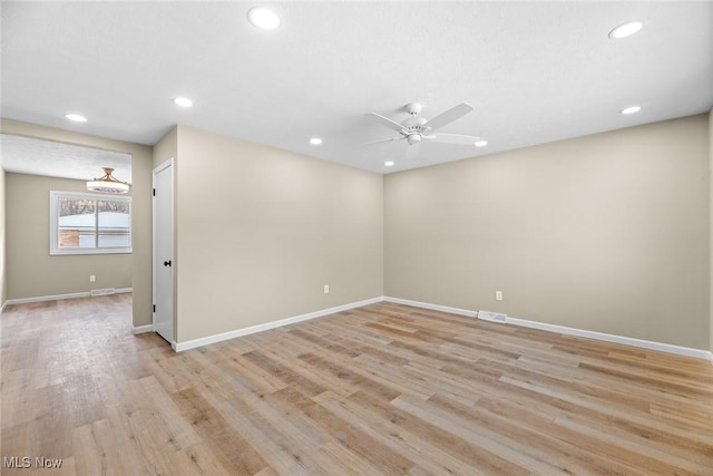 spare room featuring ceiling fan and light hardwood / wood-style floors