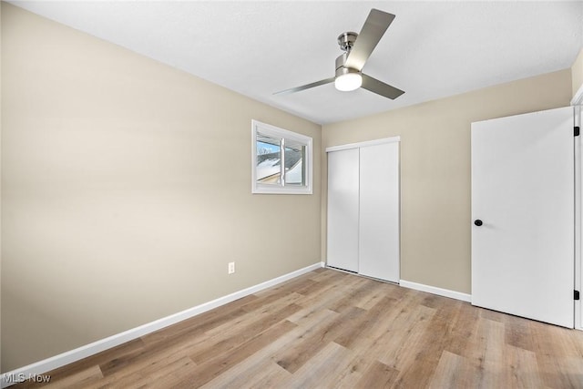 unfurnished bedroom with ceiling fan, a closet, and light hardwood / wood-style flooring