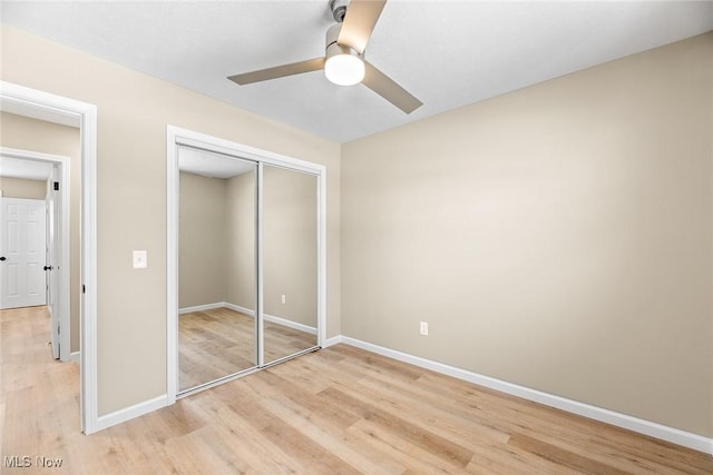 unfurnished bedroom with a closet, ceiling fan, and light wood-type flooring