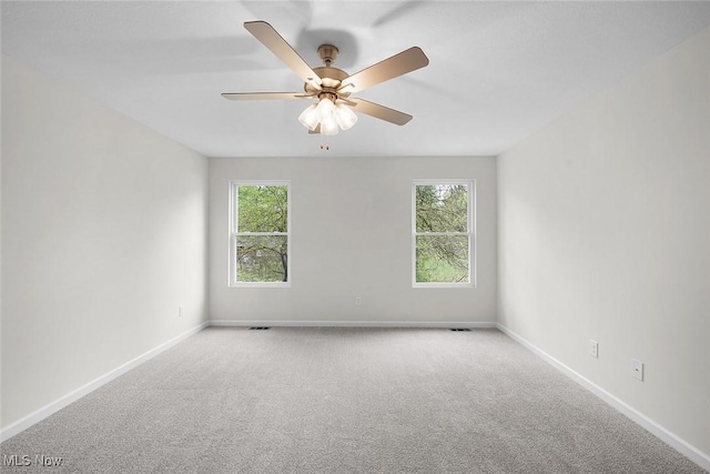 24326 Mastick Rd, North Olmsted, OH 44070 - carpeted empty room featuring healthy amount of natural light, baseboards, and ceiling fan