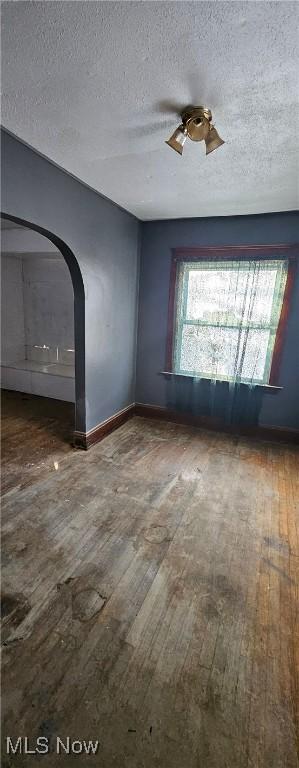 interior space with hardwood / wood-style flooring, a healthy amount of sunlight, and a textured ceiling