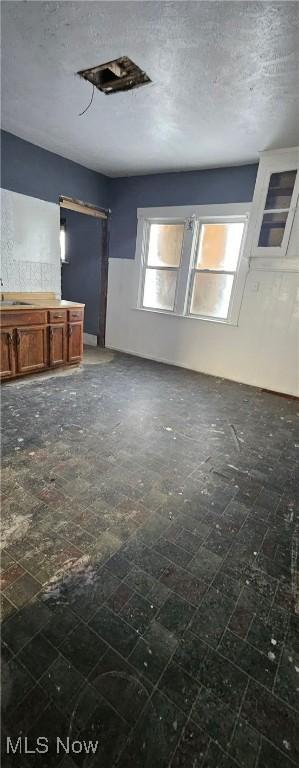 unfurnished living room with sink