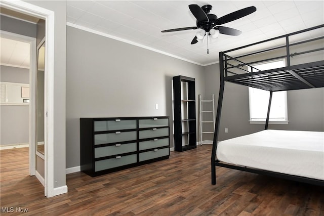 bedroom featuring ceiling fan, ornamental molding, and dark hardwood / wood-style flooring