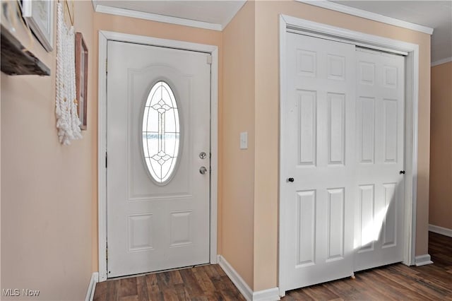 foyer entrance with dark wood-type flooring and ornamental molding