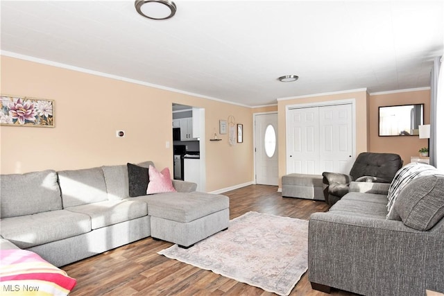 living room with crown molding and hardwood / wood-style flooring