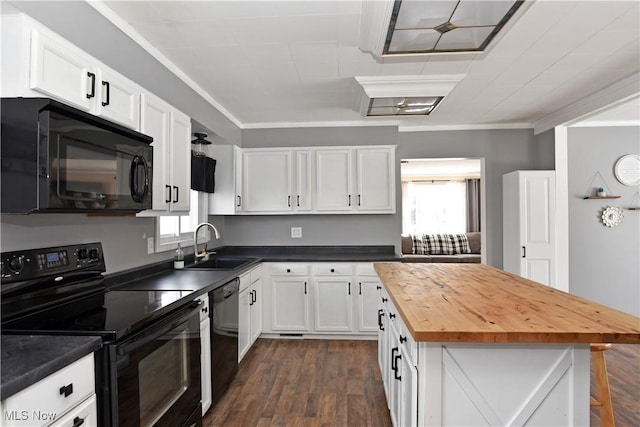 kitchen with wood counters, sink, crown molding, black appliances, and white cabinets