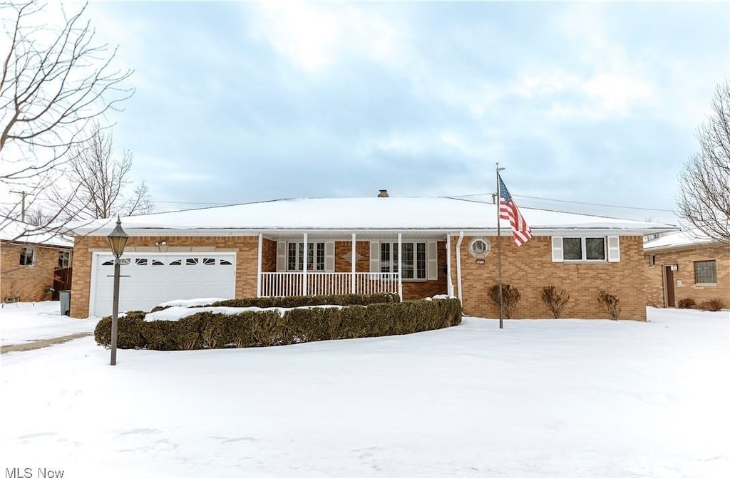 ranch-style home with a garage and covered porch