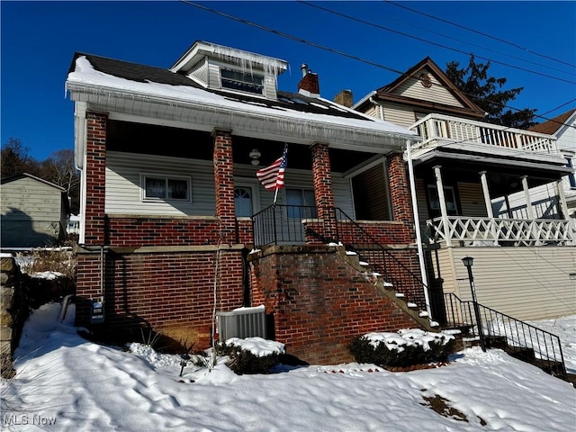 view of front of home with cooling unit and covered porch