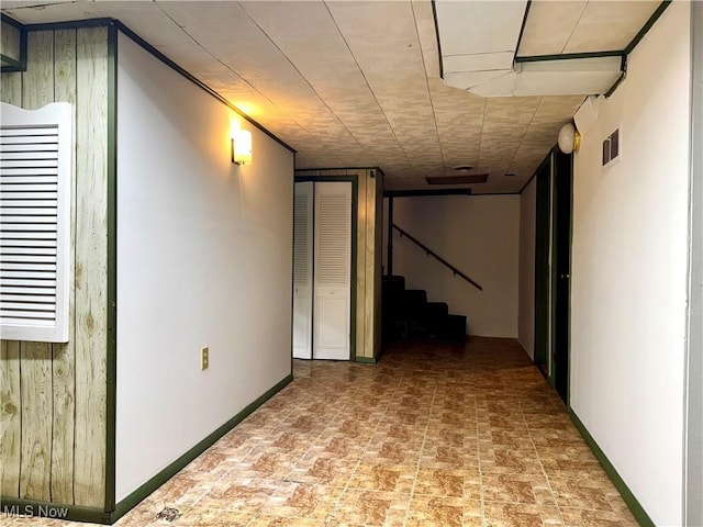 basement featuring wood walls