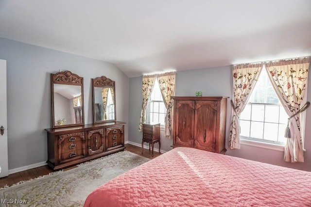 bedroom featuring vaulted ceiling and wood-type flooring