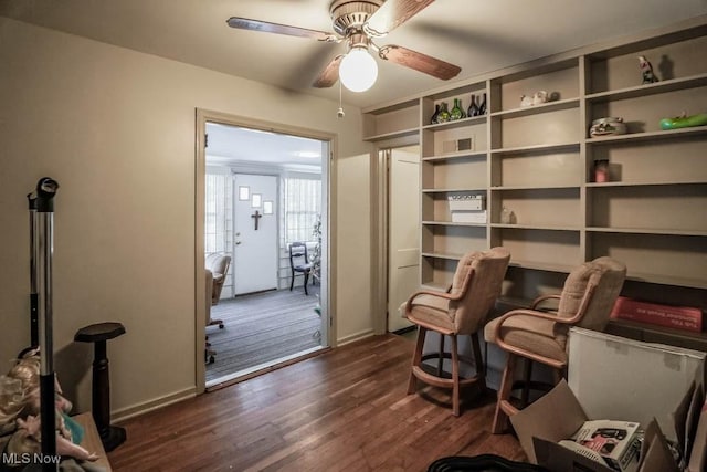 sitting room with dark hardwood / wood-style floors and ceiling fan