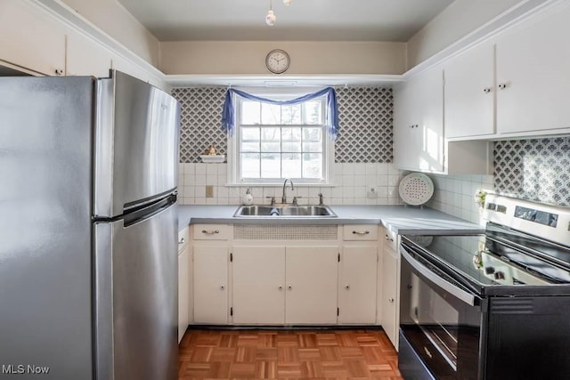 kitchen with sink, stainless steel appliances, and white cabinets