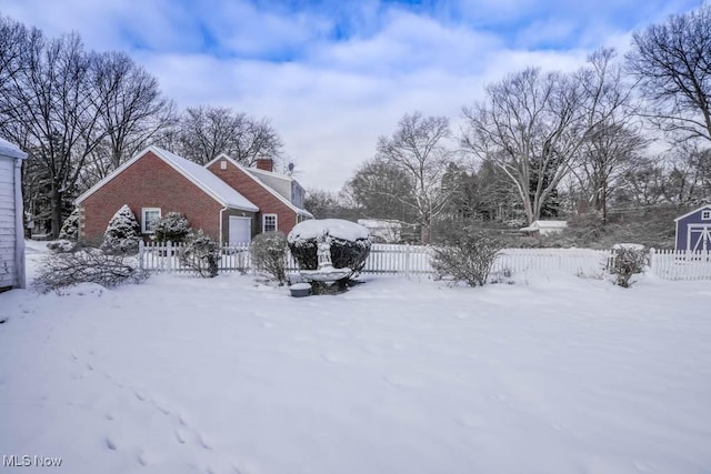 view of yard layered in snow