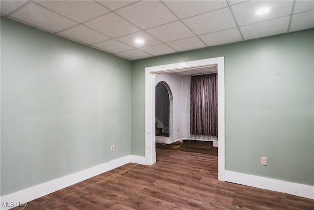 empty room featuring hardwood / wood-style flooring and a paneled ceiling