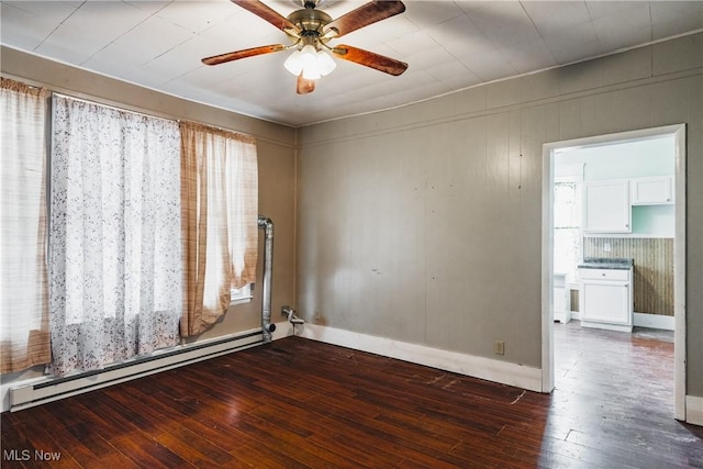 spare room featuring a baseboard radiator, dark hardwood / wood-style floors, and ceiling fan