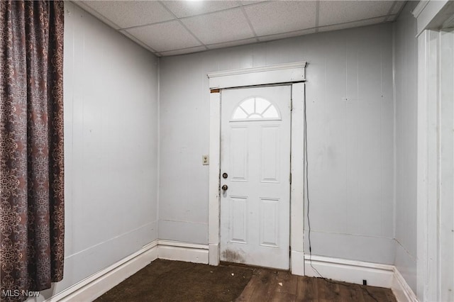 foyer entrance featuring a drop ceiling and dark hardwood / wood-style flooring