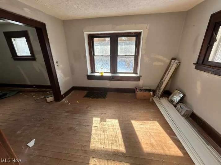 misc room with dark hardwood / wood-style floors and a textured ceiling