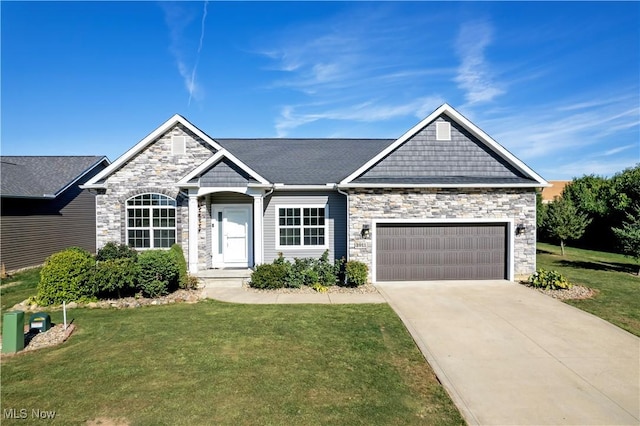 view of front of property featuring a garage and a front lawn