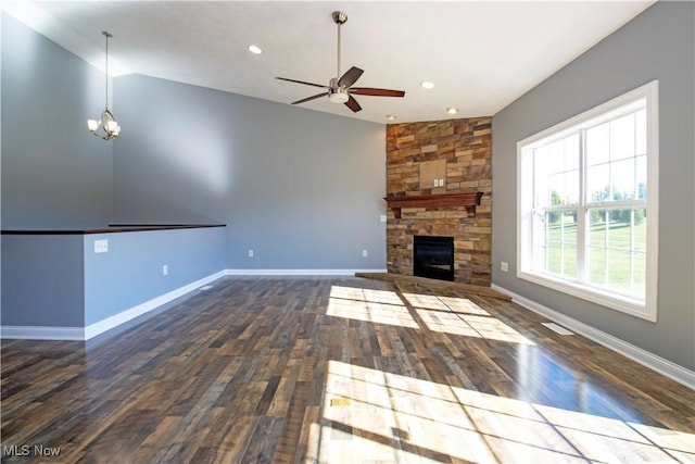 unfurnished living room featuring dark hardwood / wood-style floors, a fireplace, ceiling fan with notable chandelier, and vaulted ceiling