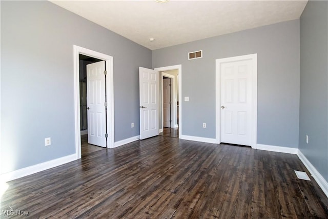 unfurnished bedroom featuring dark wood-type flooring