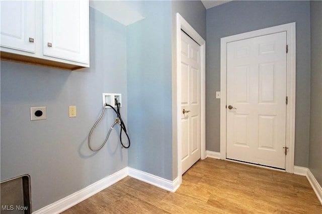 clothes washing area featuring hookup for an electric dryer, hookup for a washing machine, cabinets, and light wood-type flooring