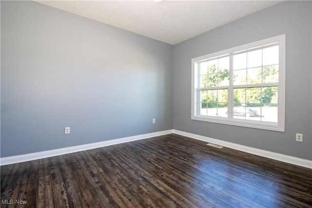 unfurnished room featuring dark hardwood / wood-style floors