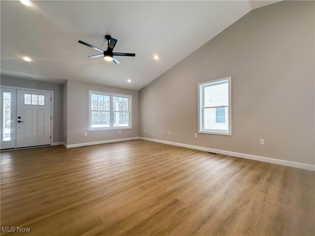 interior space featuring vaulted ceiling, ceiling fan, and light wood-type flooring