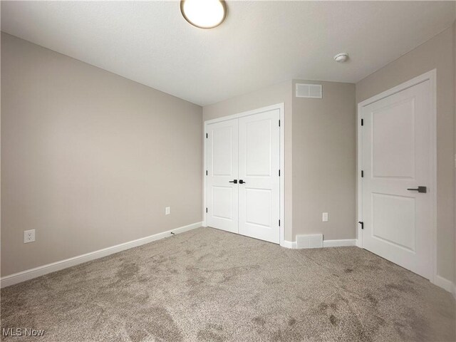 unfurnished bedroom featuring a closet and carpet