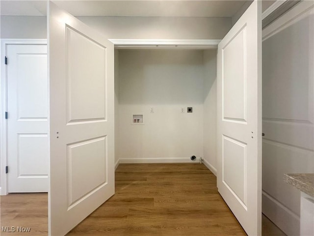 laundry room with laundry area, baseboards, light wood-style flooring, hookup for an electric dryer, and washer hookup