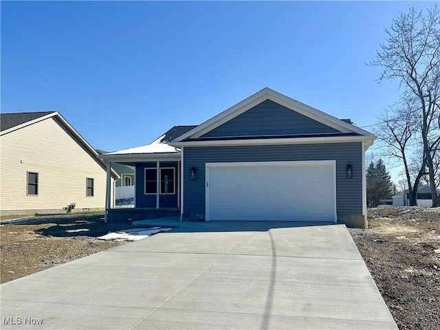 view of front facade with a garage, concrete driveway, and a porch