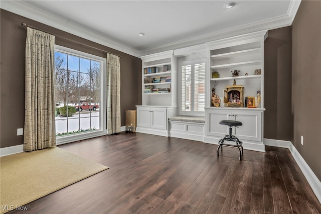 unfurnished office featuring radiator heating unit, crown molding, hardwood / wood-style floors, and built in shelves