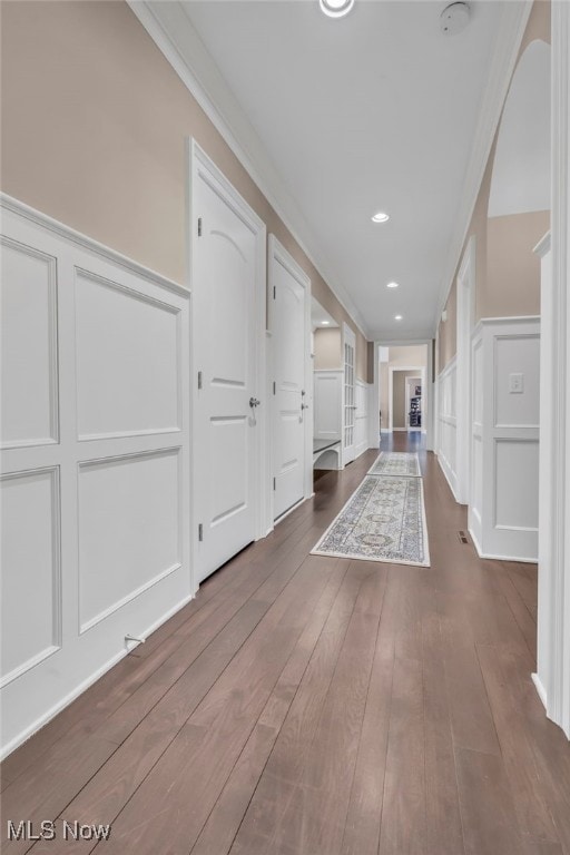 hall featuring crown molding and dark wood-type flooring