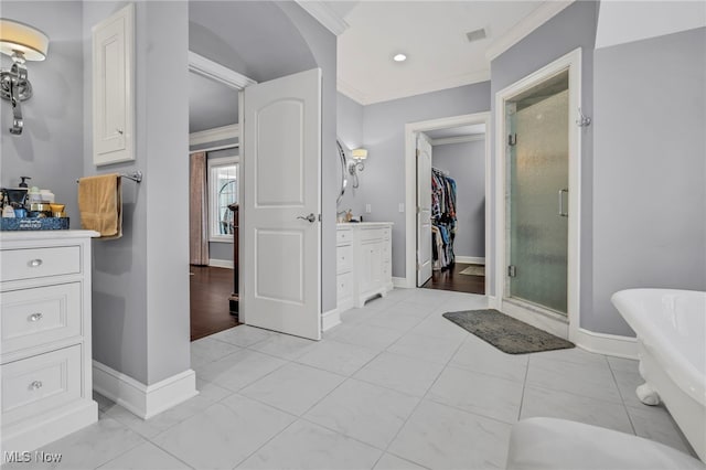 bathroom with ornamental molding, vanity, and shower with separate bathtub