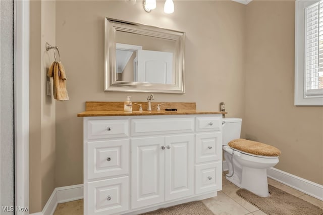 bathroom with vanity, tile patterned floors, and toilet