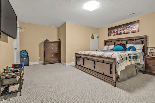 bedroom featuring light carpet