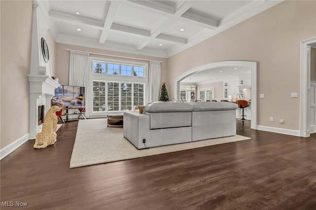 living room with beamed ceiling, a high ceiling, coffered ceiling, and dark wood-type flooring