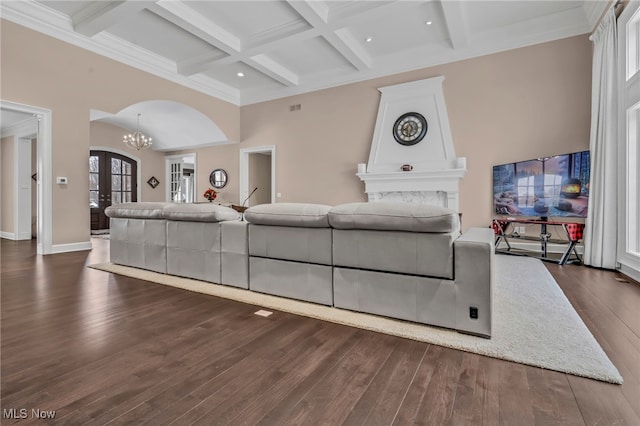 living room with french doors, coffered ceiling, dark hardwood / wood-style flooring, a notable chandelier, and beam ceiling