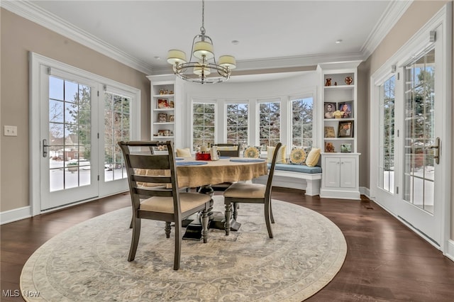 dining space featuring dark hardwood / wood-style flooring, crown molding, and a wealth of natural light