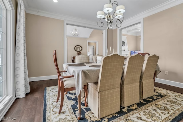 dining space featuring an inviting chandelier, ornamental molding, and dark hardwood / wood-style floors