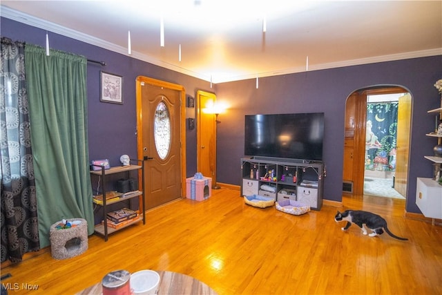 living room featuring crown molding and hardwood / wood-style floors