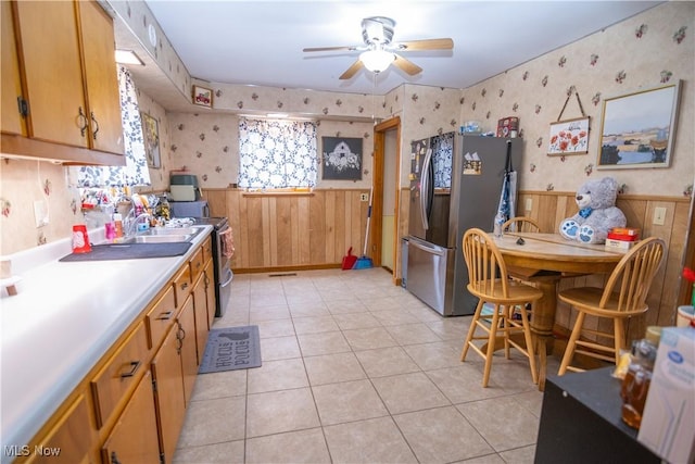 kitchen with light tile patterned flooring, ceiling fan, and appliances with stainless steel finishes