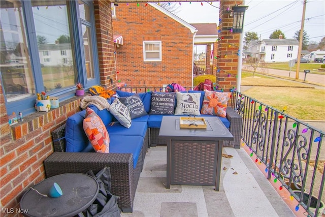 view of patio featuring an outdoor living space with a fire pit